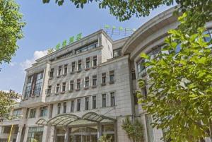 a large white building with a lot of windows at GreenTree Alliance Hotel Shanghai Baoshan District Meilan Lake Yueluo Road in Baoshan