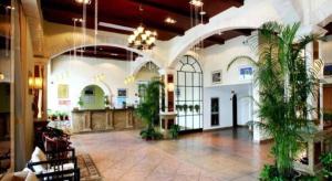 a lobby with potted plants in a building at GreenTree Alliance Hotel Shanghai Baoshan District Meilan Lake Yueluo Road in Baoshan