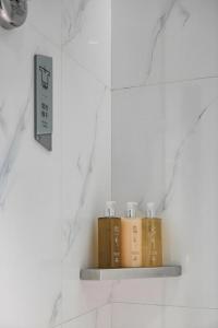 a shelf in a bathroom with three books on it at Borrman Hotel Xi'an North High-speed Railway Station in Xi'an