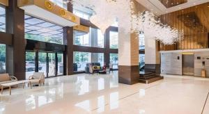 a lobby with chairs and tables in a building at City Comfort Inn Dongguan Wangniudun in Dongguan