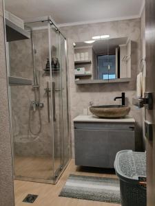 a bathroom with a shower and a sink at Beach Retreat in town in Korinthos