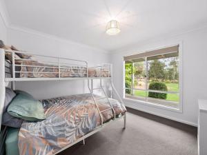 a bedroom with a bunk bed and a window at River Retreat in Yarrawonga +7 photos