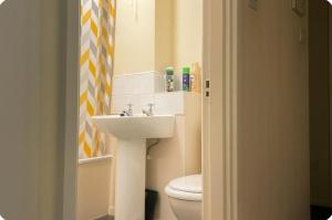 a bathroom with a sink and a toilet at Rochdale Retreat - Cozy Apartment Stay in Milnrow +13 photos