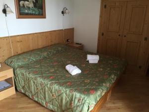 Posteľ alebo postele v izbe v ubytovaní Garni Il Muretto
