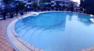a large blue swimming pool in a building at Nanning Yongjiang Hotel in Nanning