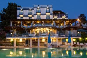 a hotel with a pool in front of a building at Soothe Hotel in Kalkan