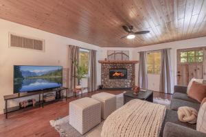 a living room with a couch and a fireplace at Peak Pursuit Jacuzzi, Sauna, Game Room, Renovated in Sugarloaf