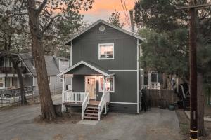a gray house with a front porch and a tree at Peak Pursuit Jacuzzi, Sauna, Game Room, Renovated in Sugarloaf