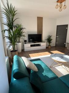 a living room with a blue couch and a tv at Apartment Stadtperle in Gotha
