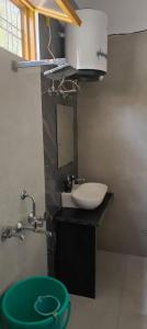 a bathroom with a sink and a mirror and a sink at Valley vibes by Bahugunas den in Srīnagar