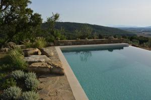 a swimming pool with a view of a mountain at Le Moraiole in Massa Marittima