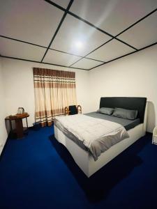 a bedroom with a large bed and a window at The Crowns Lodge in Nuwara Eliya