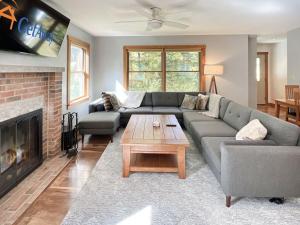 a living room with a couch and a fireplace at Hidden Kingdom home in Tyson