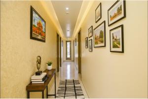 a hallway with many pictures on the walls and a table at FabHotel Punjab Pride - Near Golden temple in Amritsar