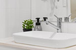 a white sink on a counter in a bathroom at Sleek & Comfortable Double Room at Revesby with Shared Amenities in Revesby