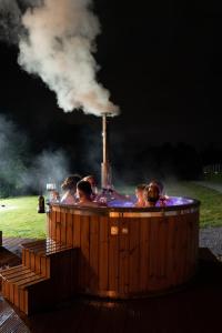 a group of people in a hot tub with smoke at Chalet Rafenstein in Moisei