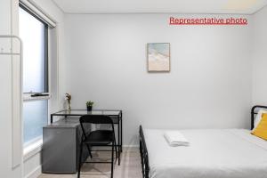 a white bedroom with a desk and a bed at Sleek & Comfortable Single Room at Revesby with Shared Amenities in Revesby