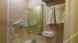 a bathroom with a shower and a sink and a mirror at Shell Hefei Luyang District Sipai Building Subway Station Hotel in Hefei +148 photos