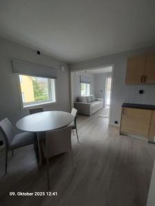 a living room with a table and a couch at Nordlys Apartment in Hamnvik