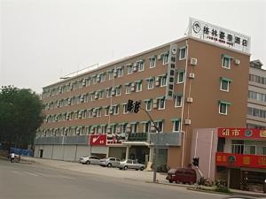 a large building with cars parked in front of it at GreenTree Inn Jinan Bus Terminal in Jinan
