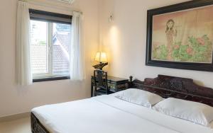 a bedroom with a bed and a window at Hue Nino Hotel in Hue +65 photos