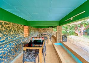 a restaurant with a colorful wall with tables and chairs at Maryland Nature Stay Wayanad by VOYE HOMES in Wayanad