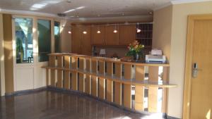a lobby with a staircase and a counter with flowers at Haus Edelweiss in Oberstdorf