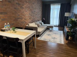 Kampong TangihanにあるTF Luxe Suites K Avenue Kepayanのソファとテーブルのあるリビングルーム