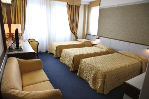 Postel nebo postele na pokoji v ubytování Hotel Maxim