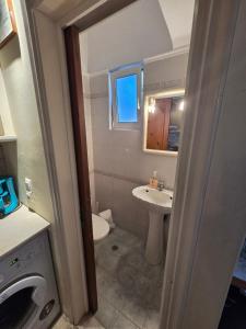 a small bathroom with a sink and a toilet at center apartments in Lefkada Town +40 photos