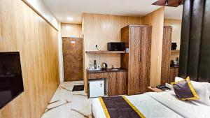 a bedroom with wooden walls and a bed in a room at TIM Santacruz Mumbai Airport in Mumbai