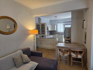 a living room with a couch and a dining room table at center apartments in Lefkada Town
