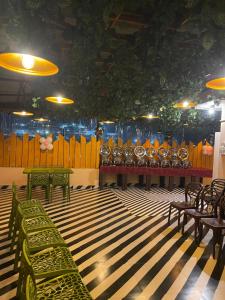 a room with a bunch of green benches in a room at Anagh Guest House in Shillong