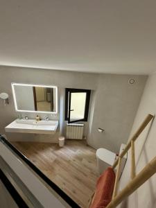 a bathroom with a sink and a mirror at Charming village house for families & cyclists in Juià