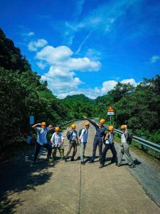 a group of people wearing hard hats on a road at Phong Nha Ecolodge Homestay & Tours - Mountain View in Phong Nha +45 photos