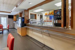 a fast food restaurant with a counter and chairs at Comfort Suites in Marquette