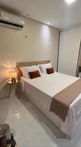 a bedroom with a large bed in a room at Vila jequitimar in Guarujá