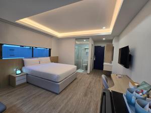 Ένα ή περισσότερα κρεβάτια σε δωμάτιο στο House Hotel Pattaya Sai 3