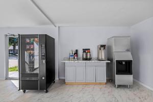 a kitchen with two refrigerators next to a counter at Suburban Studios Newport News - Hampton in Newport News