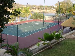 a tennis court with a tennis court at Lake Kariba Inns in Siavonga