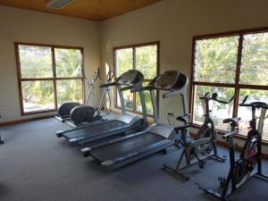 a gym with several tread machines and windows at Lake Kariba Inns in Siavonga