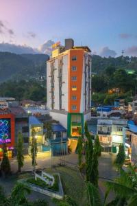 a city with a tall building in the foreground at Front One Hotel Jayapura in Jayapura