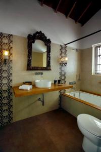 a bathroom with a sink and a tub and a toilet at ELIVAAS Terra Rosa Portuguese-styled 4-BHK Villa With Private Pool, Garden, Veranda & Sit-out Area in Vainguinim