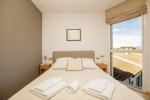 a bedroom with a large bed with two white towels at Apartamento con vistas Peralada in Peralada