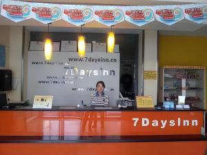 a woman standing behind a counter in a store at 7Days Inn Jining Zoucheng Sports Park in Jining
