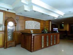 a large room with a counter in a building at Larisae Setia Kawan Hotel in Solo
