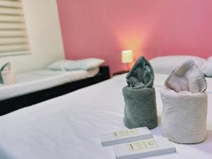 Postel nebo postele na pokoji v ubytování RNJ Hotel Baguio