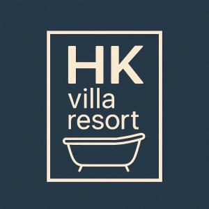 a sign that reads hk villa resort with a bathtub at HK Villa Resort in Bangkok