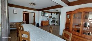 a dining room with a table and chairs and a room at Craii Neamtului in Almaş
