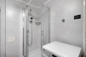 a white bathroom with a shower and a toilet at Casa Maria Beatrice in Mühlbach
